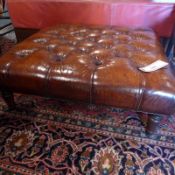 A buttoned dark tan leather hearth stool of square form,