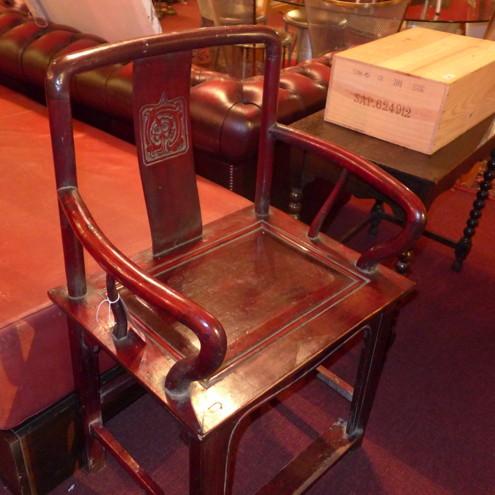 A Chinese lacquered throne chair raised on stretchered supports