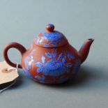 A Chinese Yixing teapot with enamel flor