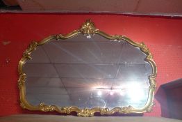 A Rococo style giltwood mirror with shap