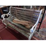 A white painted cast iron garden bench