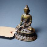 A bronze Buddha, holding an Alms bowl an