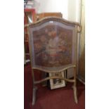 A giltwood fire screen with inset tapest