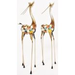 A pair of metal sculptures of antelopes