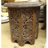 An octagonal carved Islamic style table with carved vine pattern