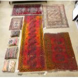 An Afghan golden runner, prayer rug, similar rugs and a collection of kilim cushions