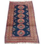 An antique Kurdish rug, the central pole medallion design on a midnight blue ground, within multiple