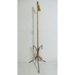 A mid-Century French designer gilt metal standard lamp of faux bamboo form raised on splayed