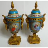 A fine pair of ormolu mounted sevres urns painted with lovers