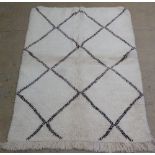 A genuine vintage Berber (Beni Ourain) rug, the all over twin line geometric lozenge design on a