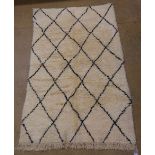 A vintage Moroccan Berber (Beni Ourain) rug, the all over geometric lozenge design on a thick