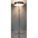 A contemporary designer uplighter having mesh lined chrome shade raised on central chrome column and