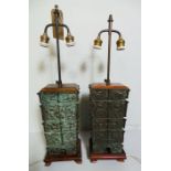 A pair of Oriental bronze table lamps, having red silk shades (2)