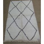 A genuine vintage Berber (Beni Ourain) rug, the all over twin line geometric lozenge design on a