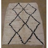 A Morrocan Berber (Beni Ourain) rug, the typical lozenge design on an ivory ground, 152cm x 210cm