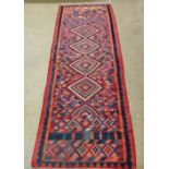 A vintage Afghan kilim rug, the pole medallion and all over geometric on a terracotta and sky blue