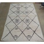 A genuine vintage Berber (Beni Ourain) rug, the all over geometric lozenge design with repeated