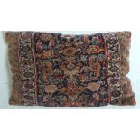 A late 19th Century large cushion upholstered in Caucassian carpet