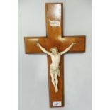 An late 19th Century burr wood crucifix with ivory Christ