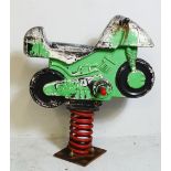 A vintage children's fairground rocking toy in the form of a motorbike