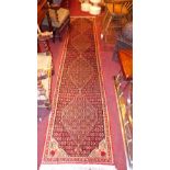 An extremely fine North West Persian Senneh runner 327cm x 70cm within repeating Heratio motifs