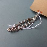 A 9ct white gold and diamond bracelet in the form of hearts