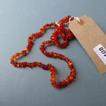 An amber necklace and amber inset ring
