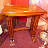 A mahogany nest of three low tables on t