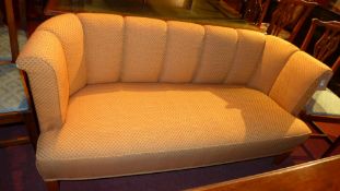 A contemporary designer two seater club sofa upholstered in orange patterned fabric