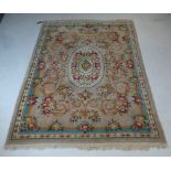 A Chinese rug, the central floral oval medallion with all over floral motifs on a camel ground