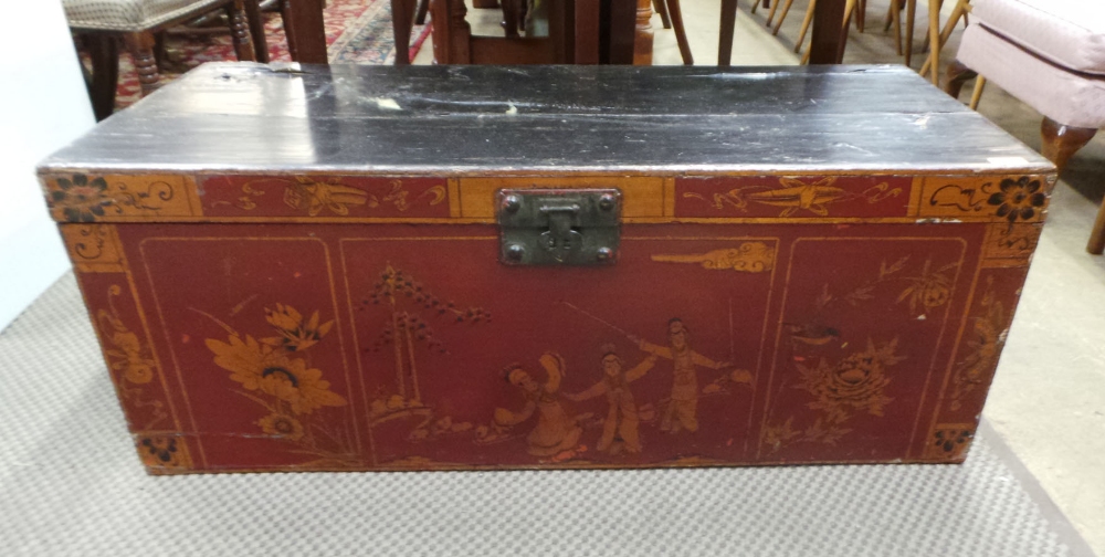 An Oriental red and black lacquered camphorwood trunk with figural decoration