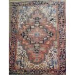 A fine antique Persian Heriz carpet, the central geometric medallion on a terracotta ground with