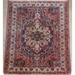 A fine North West Persian rug, the large intricate central blue medallion on a ruby ground within