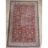 A kazak rug, the all over typical design on a terracotta ground within wide ivory border with