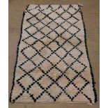A Morrocan Berber (Beni Ourain) rug, the stippled geometric lozenge design on a thick piled
