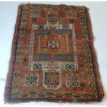 An antique Khorchof kazak rug, the central geometric medallion on a terracotta ground within