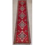 A fine South West Persian Qashgai runner, 330cm x 70cm, repeating stylised pole medallions with