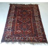 An Antique Persian Qashaquin rug, the triple pole medallion on a Scarlett ground with all over
