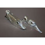 A PAIR OF WHITE METAL DECORATIVE WALL HANGING CLIPS IN THE SHAPE OF DUCK AND PIKE'S HEAD