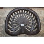 A LARGE CAST IRON TRACTOR SEAT