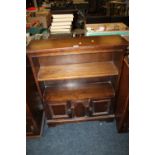 AN OAK OPEN BOOKCASE WITH CARVED DETAIL