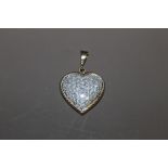 A HEART SHAPED 9CT GOLD DIAMOND ENCRUSTED PENDANT