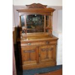 AN OAK ART NOUVEAU CARVED MIRRORBACKED SIDEBOARD