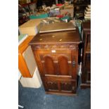 AN OAK LINENFOLD HI-FI CABINET