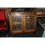 AN OAK OLD CHARM HANGING GLAZED BOOKCASE