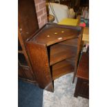 A SMALL OPEN OAK CORNER CABINET