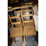 A SET OF FOUR PINE CHAIRS