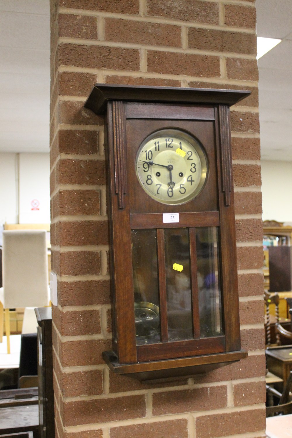 AN OAK CASED WALL CLOCK