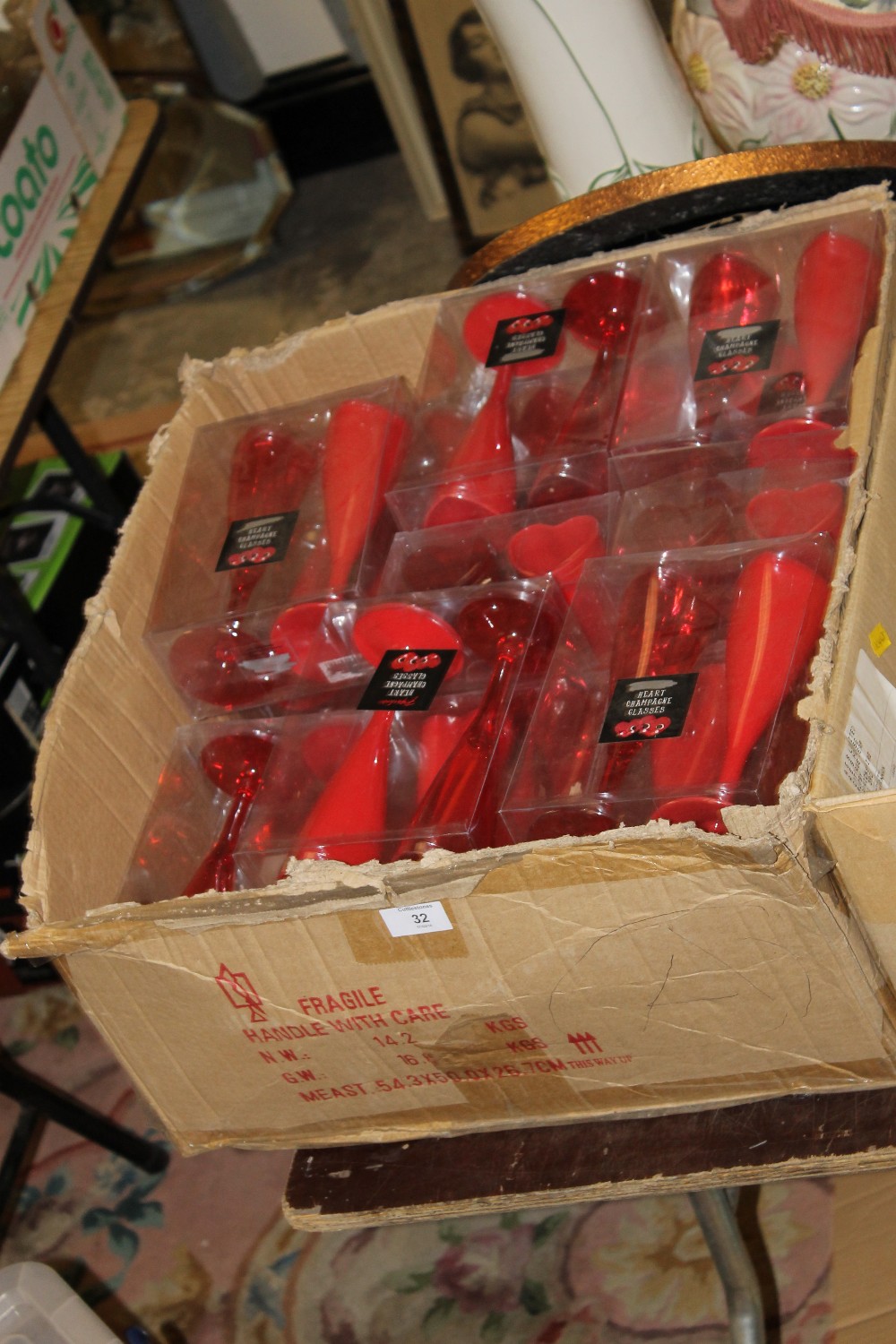 A BOX OF HEART SHAPED PLASTIC CHAMPAGNE FLUTES