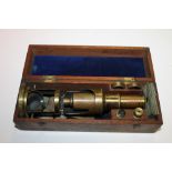 A VINTAGE CASED BRASS MICROSCOPE